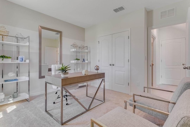 carpeted home office featuring visible vents and baseboards