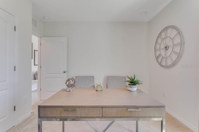 office featuring light colored carpet, visible vents, and baseboards