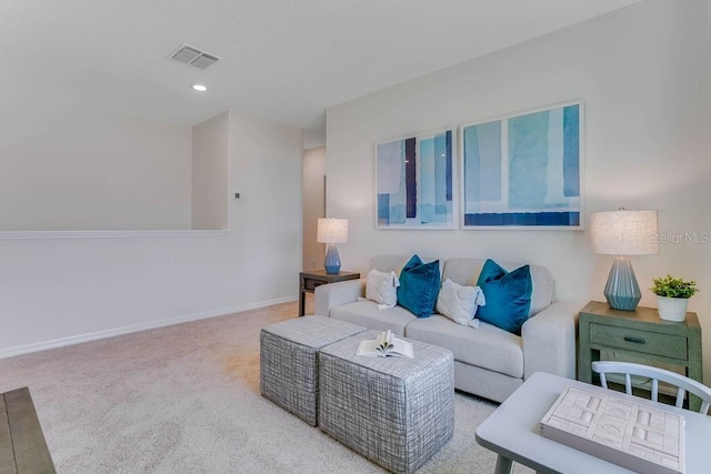 carpeted living area featuring baseboards, visible vents, and recessed lighting