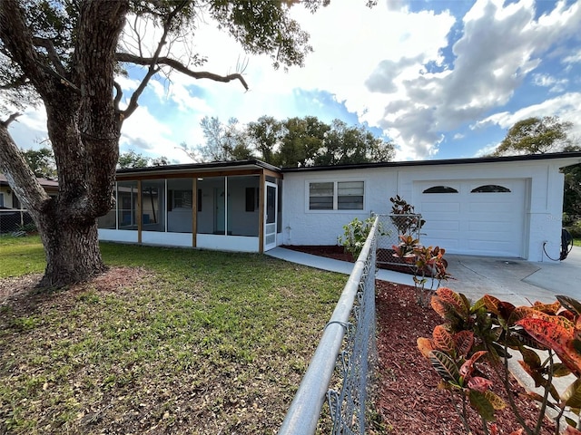 single story home with a sunroom, fence, a garage, driveway, and a front lawn