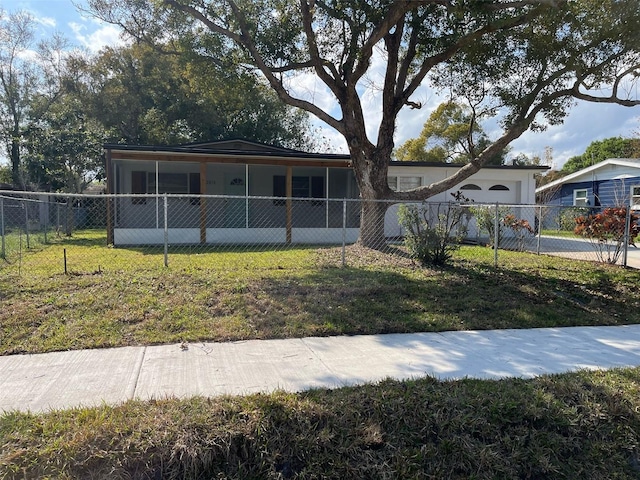 view of front of home featuring a fenced front yard, concrete driveway, an attached garage, and a front lawn