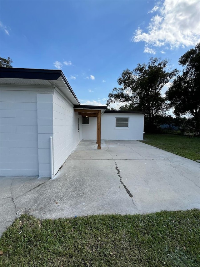 view of home's exterior featuring a patio and a yard