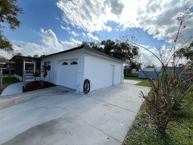 garage featuring concrete driveway