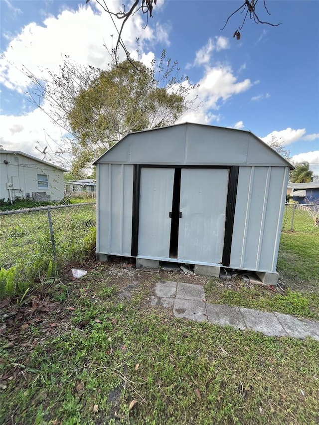 view of shed with fence