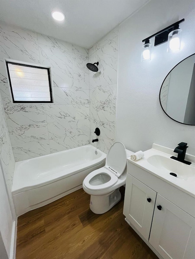 full bathroom with toilet, wood finished floors, vanity, washtub / shower combination, and recessed lighting