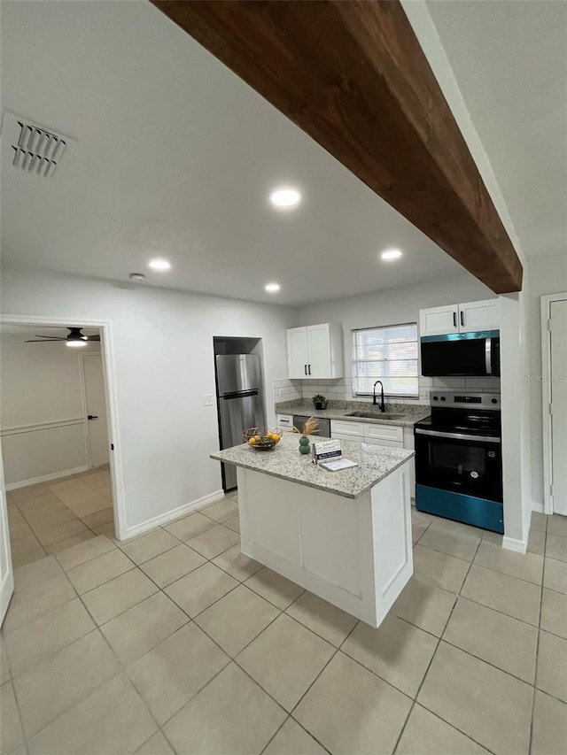 kitchen featuring light tile patterned floors, visible vents, appliances with stainless steel finishes, white cabinetry, and a sink