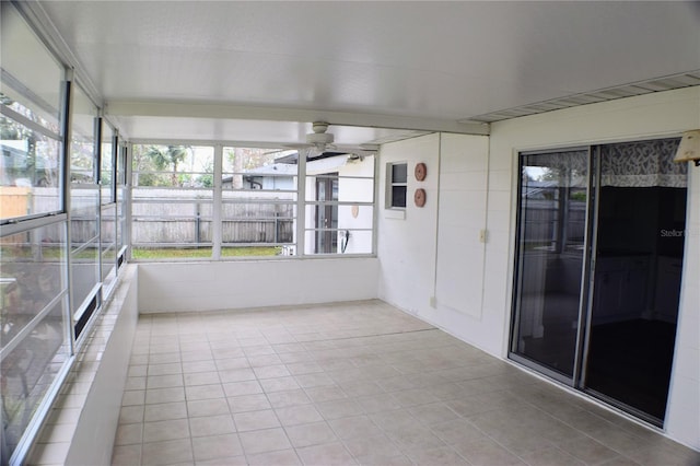 unfurnished sunroom featuring a ceiling fan