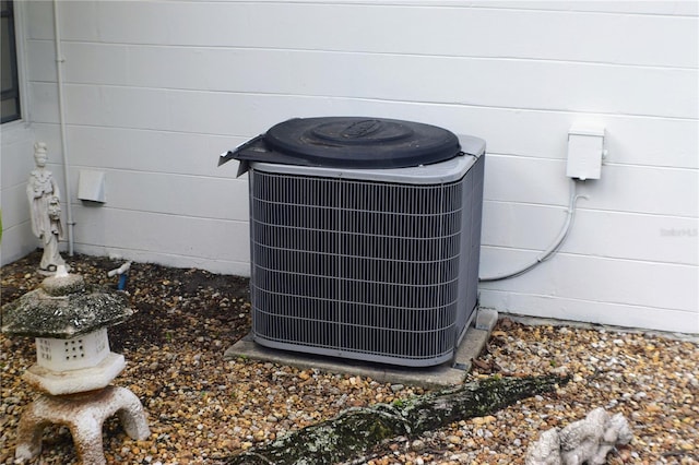 exterior details featuring cooling unit and concrete block siding