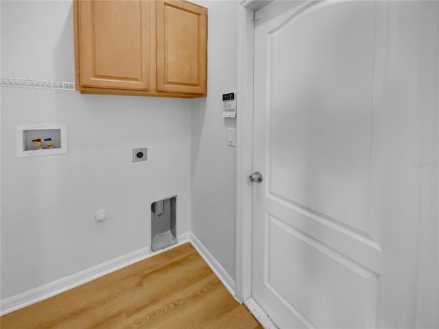 clothes washing area featuring hookup for a washing machine, cabinet space, electric dryer hookup, wood finished floors, and baseboards