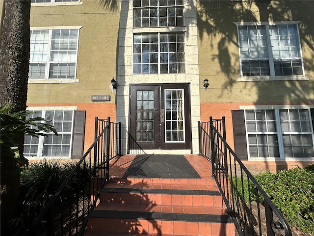 entrance to property featuring stucco siding