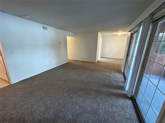 unfurnished room with carpet and visible vents