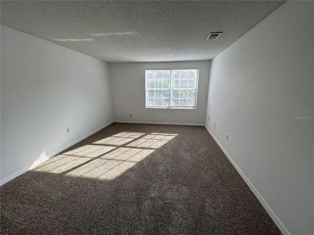 unfurnished room featuring light carpet, a textured ceiling, visible vents, and baseboards