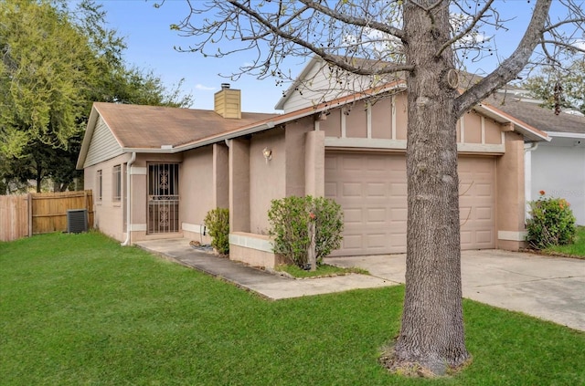 view of front of home with concrete driveway, a chimney, an attached garage, fence, and a front lawn