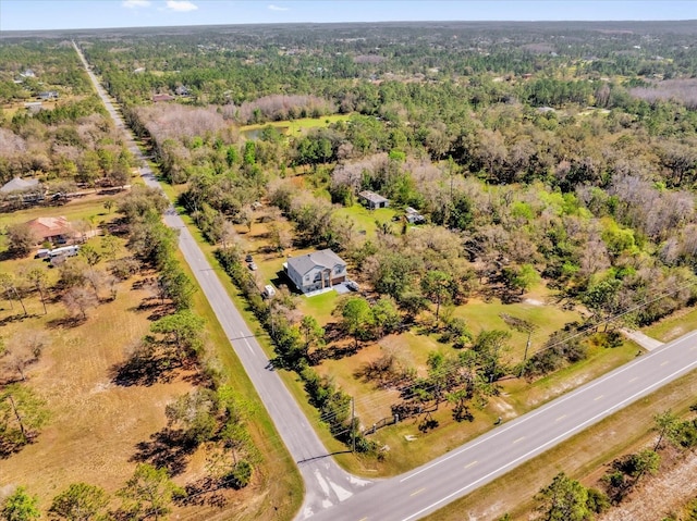 drone / aerial view with a wooded view