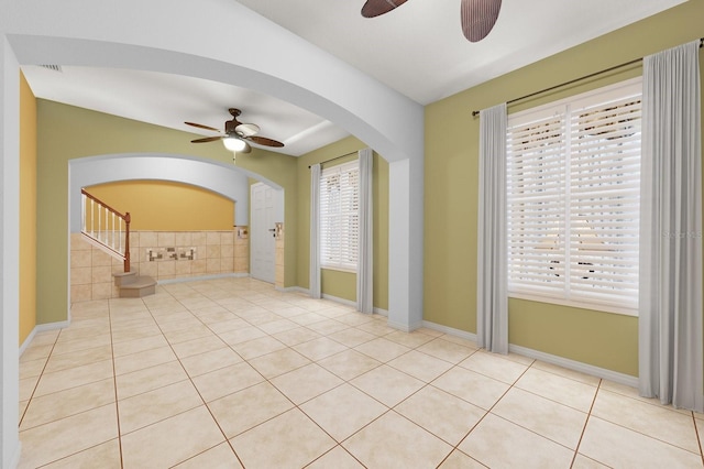 unfurnished room featuring visible vents, ceiling fan, stairway, and tile patterned floors