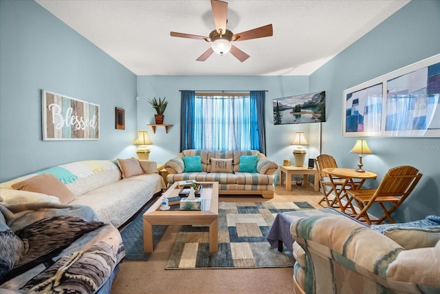 carpeted living room with ceiling fan