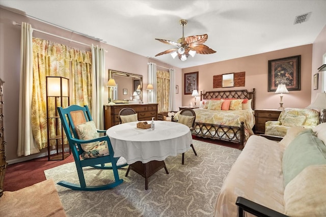 living area with ceiling fan, carpet floors, and visible vents