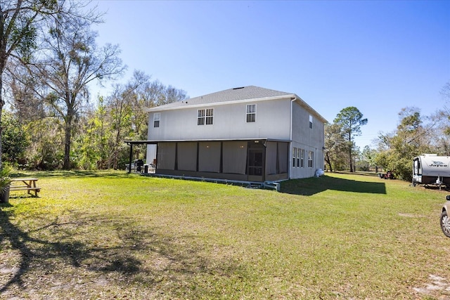 rear view of property featuring a lawn