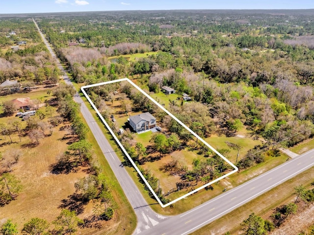 drone / aerial view featuring a view of trees