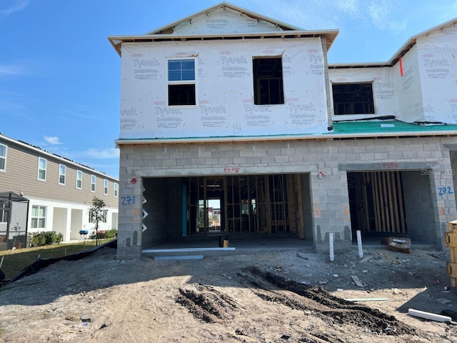 rear view of house with a garage