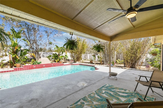 view of pool with a fenced in pool, a patio, a fenced backyard, and a ceiling fan