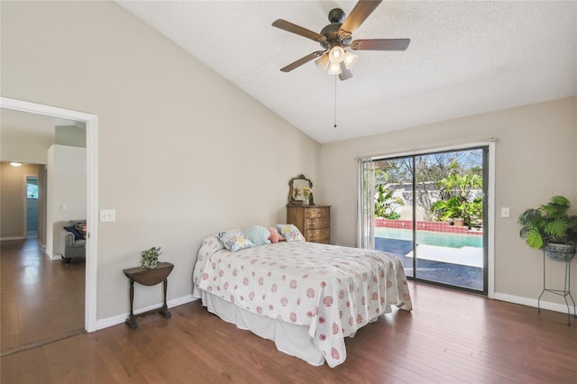 bedroom featuring baseboards, wood finished floors, lofted ceiling, and access to outside