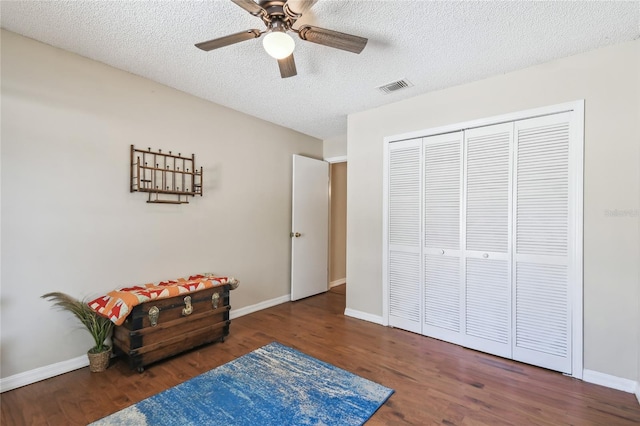 sitting room featuring visible vents, baseboards, and wood finished floors