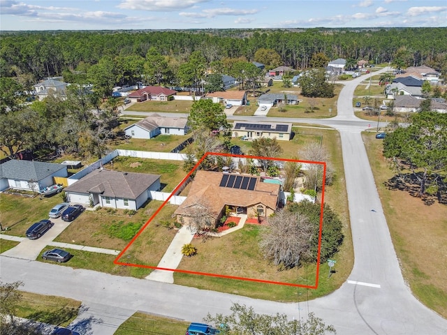 birds eye view of property with a wooded view and a residential view