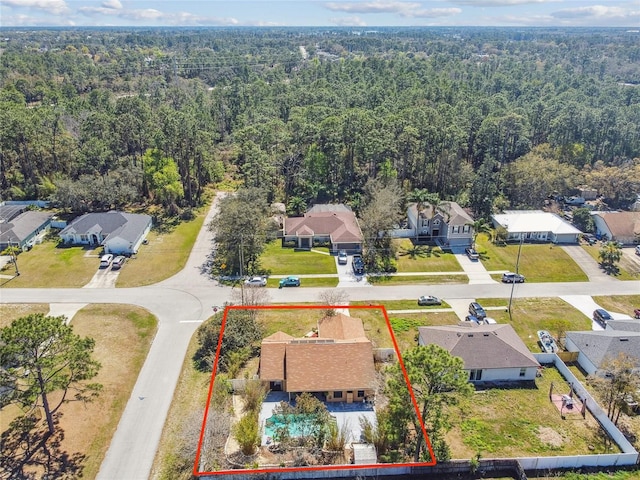 aerial view featuring a residential view and a wooded view