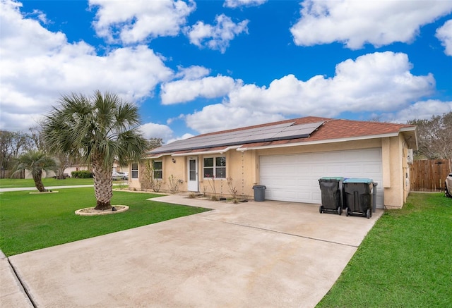 view of front of home featuring a garage, concrete driveway, solar panels, a front lawn, and stucco siding