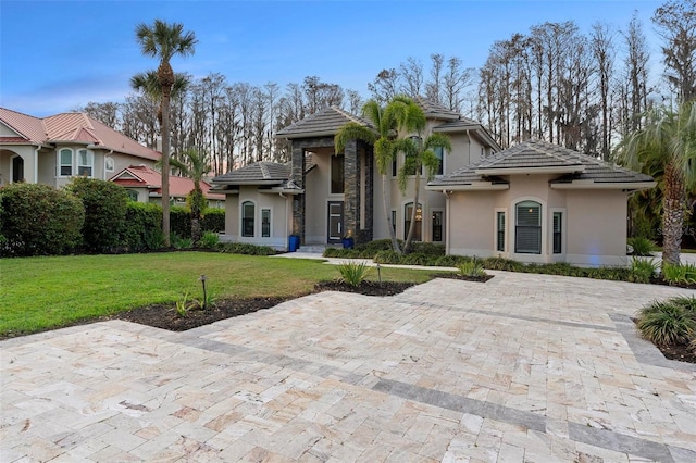 5524 Sail Ct, Orlando, FL 32819 - view of front facade with stucco siding, a front lawn, and a tiled roof