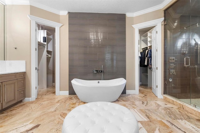 5524 Sail Ct, Orlando, FL 32819 - full bathroom with a spacious closet, vanity, a soaking tub, a shower stall, and ornamental molding