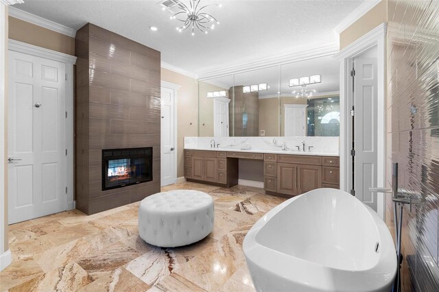 5524 Sail Ct, Orlando, FL 32819 - full bathroom with double vanity, crown molding, a soaking tub, a multi sided fireplace, and a chandelier