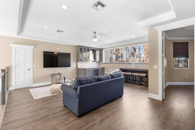 5524 Sail Ct, Orlando, FL 32819 - living room featuring crown molding, a ceiling fan, baseboards, wood finished floors, and healthy amount of natural light