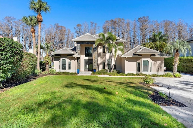 5524 Sail Ct, Orlando, FL 32819 - view of front of home featuring stucco siding, a tiled roof, and a front lawn