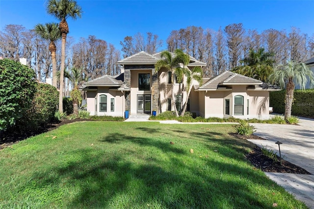 5524 Sail Ct, Orlando, FL 32819 - view of front facade with stucco siding, a tile roof, and a front lawn
