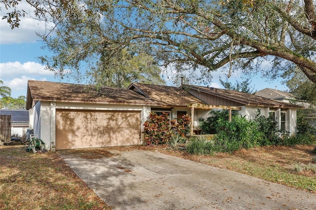 ranch-style home featuring concrete driveway and an attached garage