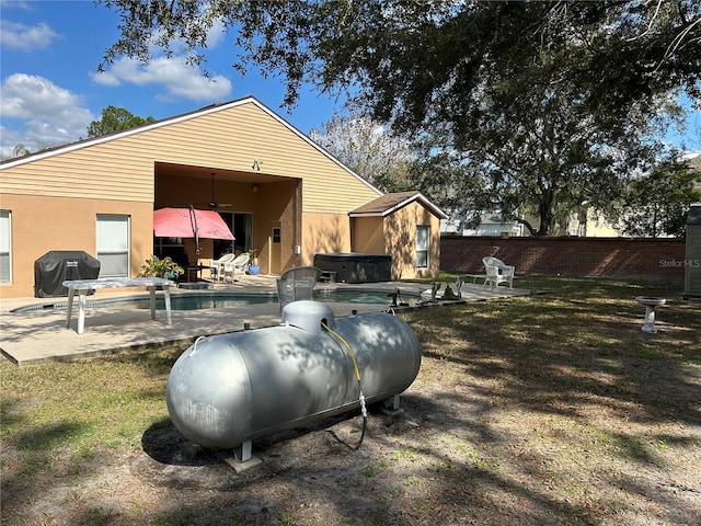 view of home's exterior featuring a patio, a fenced backyard, stucco siding, a swimming pool, and a lawn