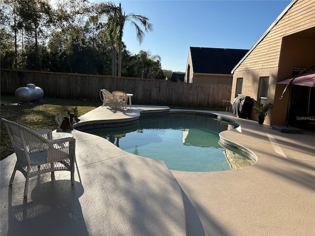 view of pool featuring a fenced in pool, a fenced backyard, and a patio area