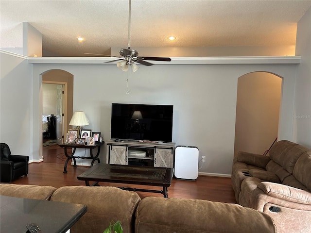 living area with recessed lighting, wood finished floors, arched walkways, and baseboards