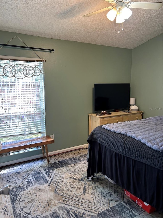 bedroom with baseboards, a textured ceiling, and ceiling fan