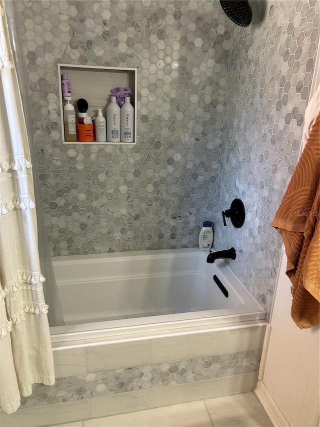 bathroom with tile patterned floors and tiled shower / bath combo