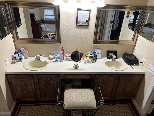 full bathroom with a sink and double vanity