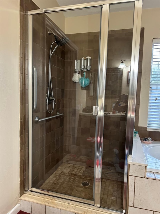 bathroom with a shower stall and a garden tub