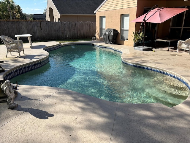 view of swimming pool with a fenced in pool, area for grilling, a patio area, and fence