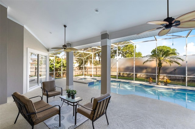 view of pool featuring a patio, glass enclosure, ceiling fan, fence, and a pool with connected hot tub