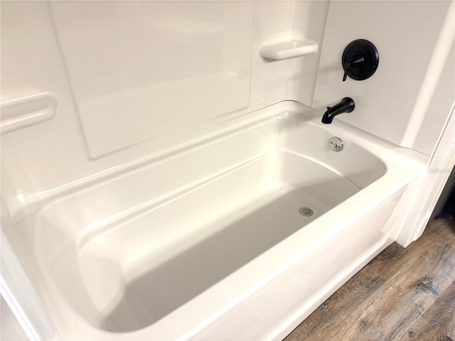 bathroom featuring a tub and wood finished floors