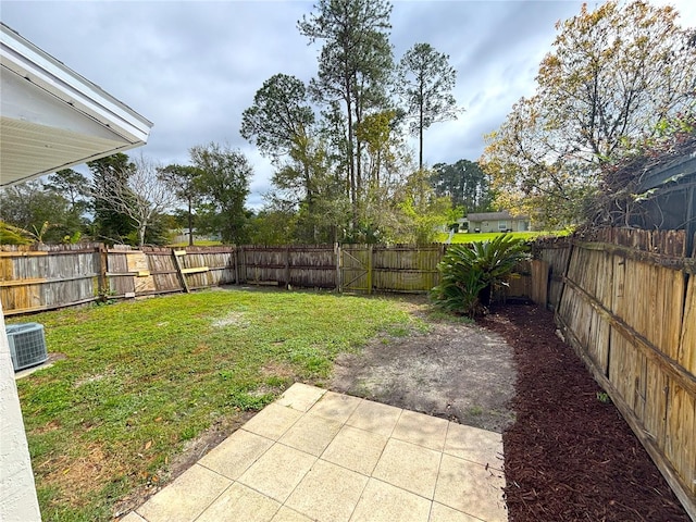 view of yard featuring central AC unit, a patio area, and a fenced backyard