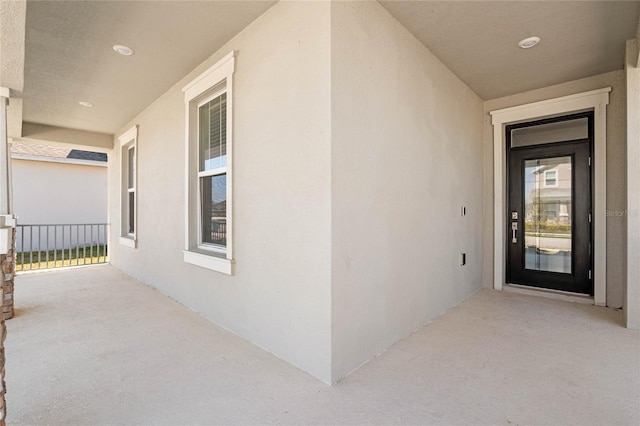 view of exterior entry with stucco siding