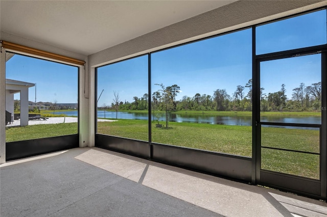 unfurnished sunroom with a healthy amount of sunlight and a water view